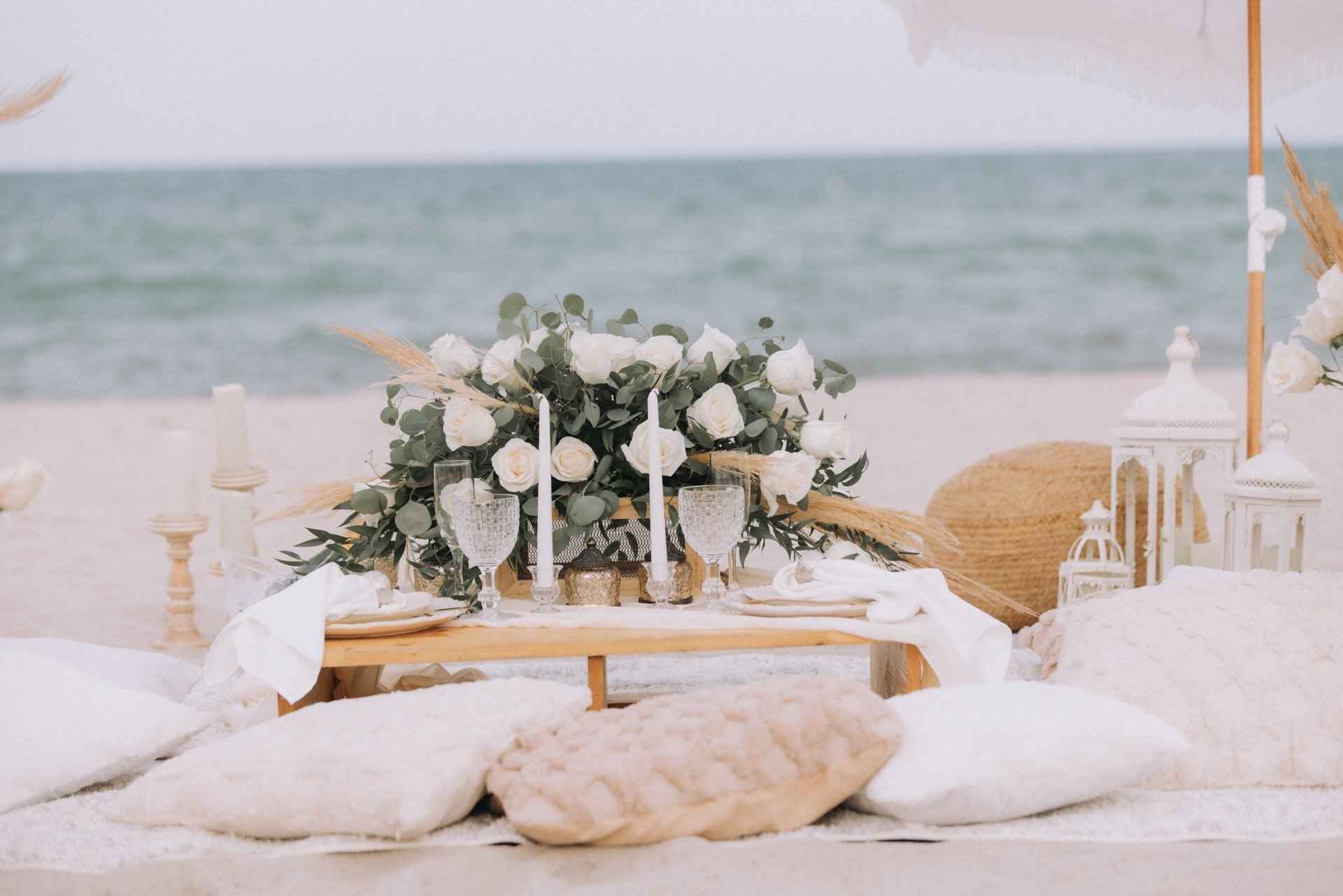 Low lounge picnic with cushions and flowers on the beach