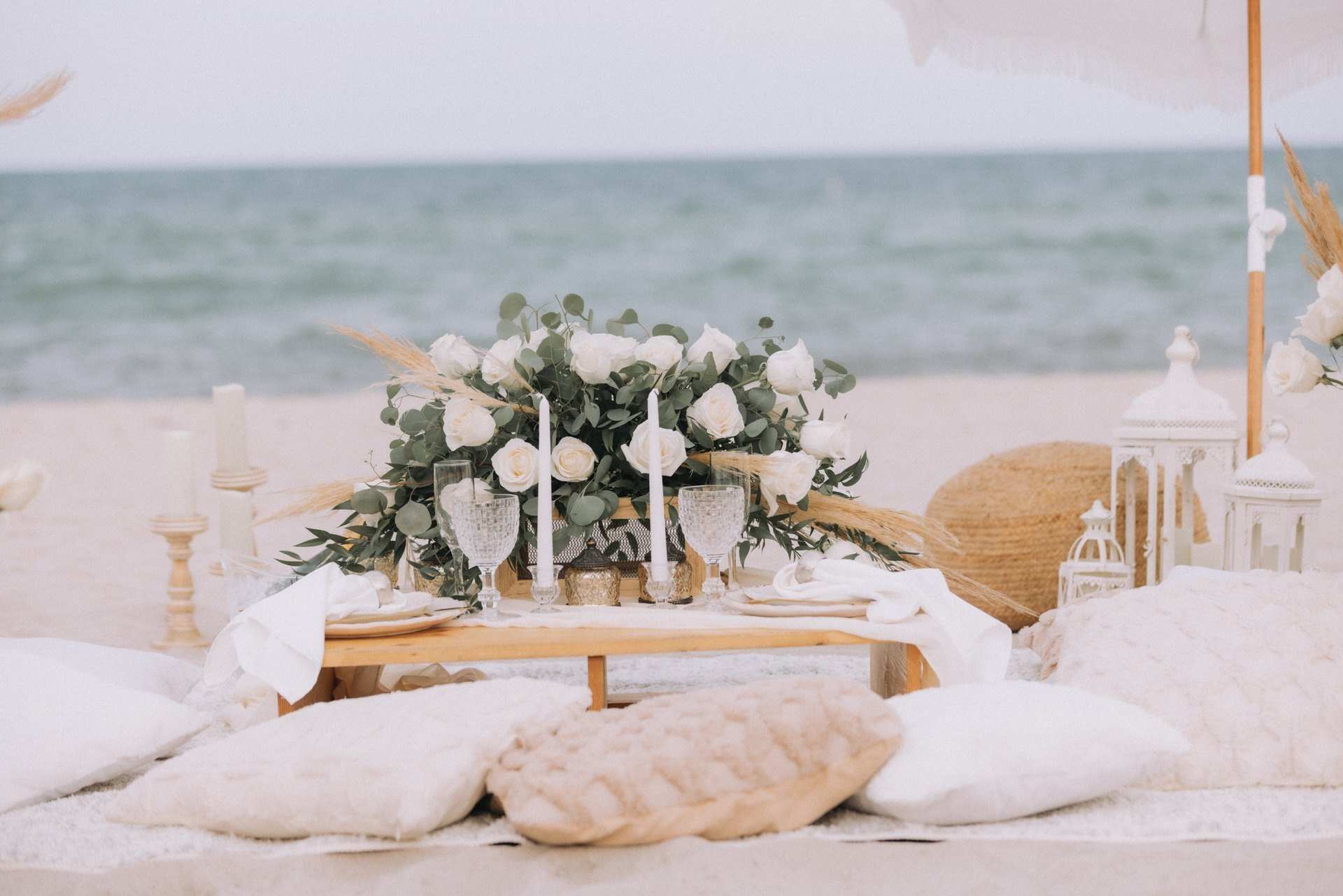 Low lounge picnic with cushions and flowers on the beach
