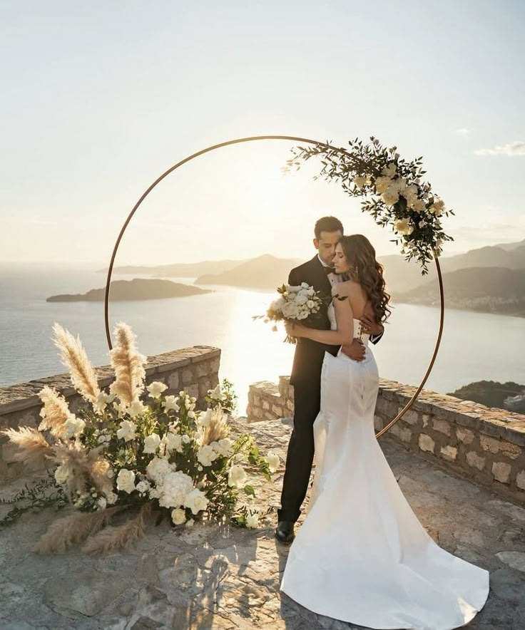 Couple under a circle arch with ground flowers