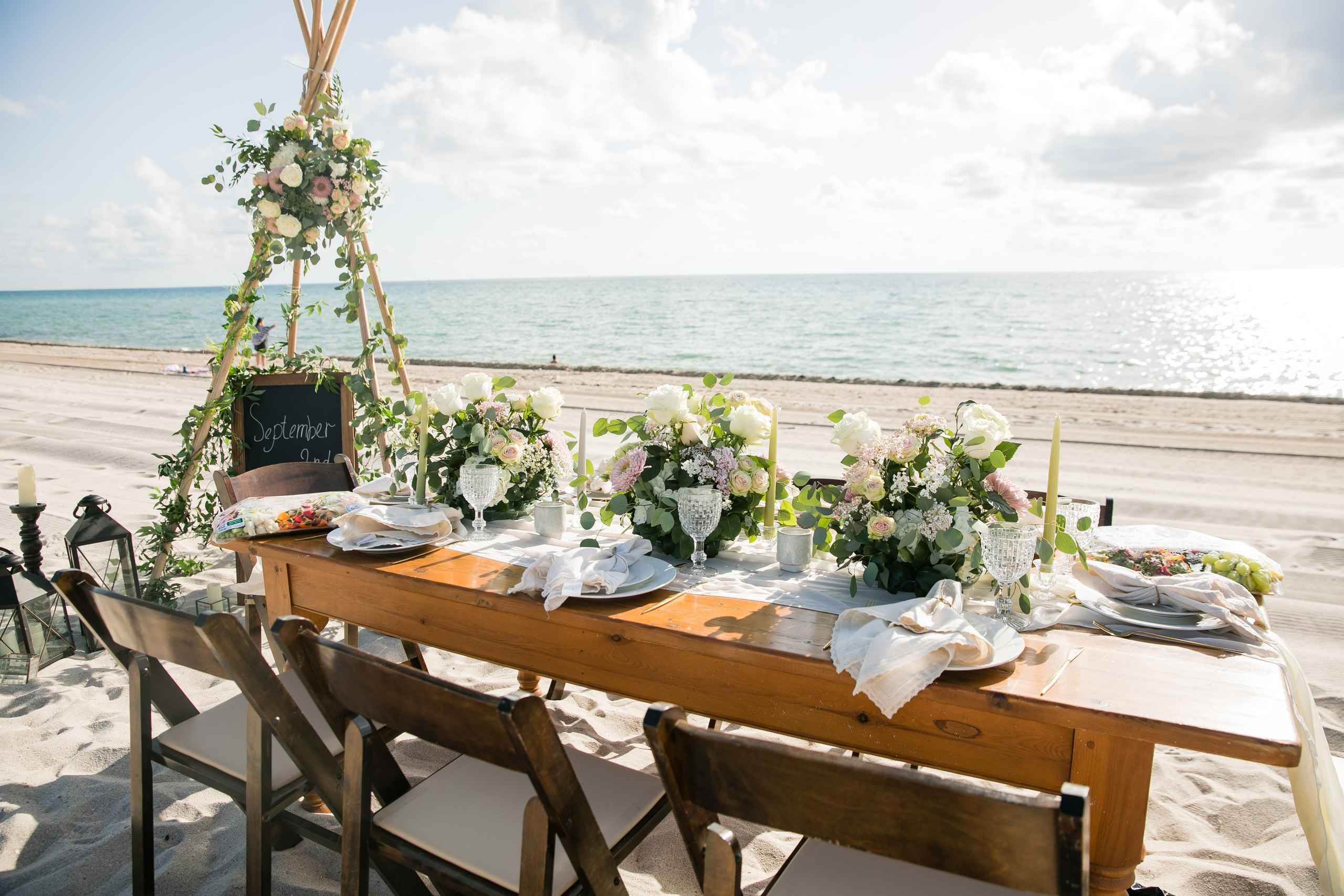 Long table under a canopy on the beach