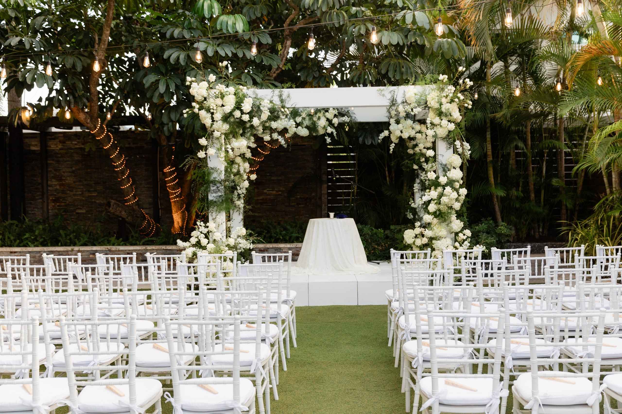 Four post canopy with white fabric in a garden