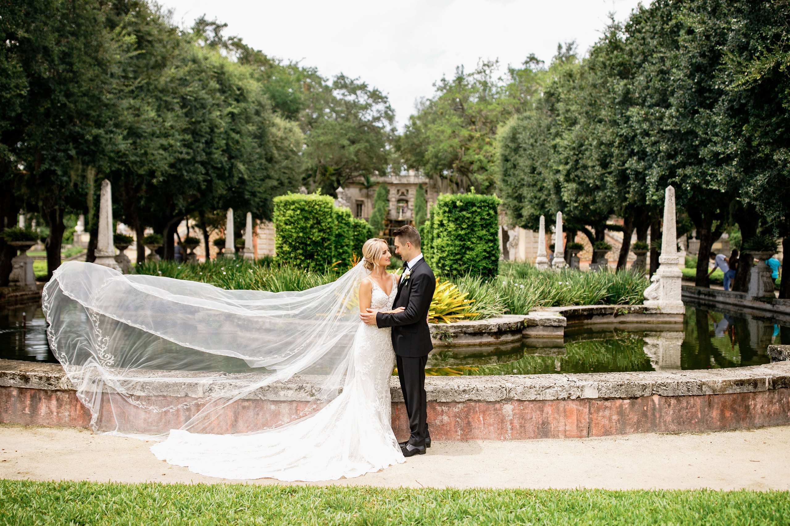 Couple under a flowing veil in a park