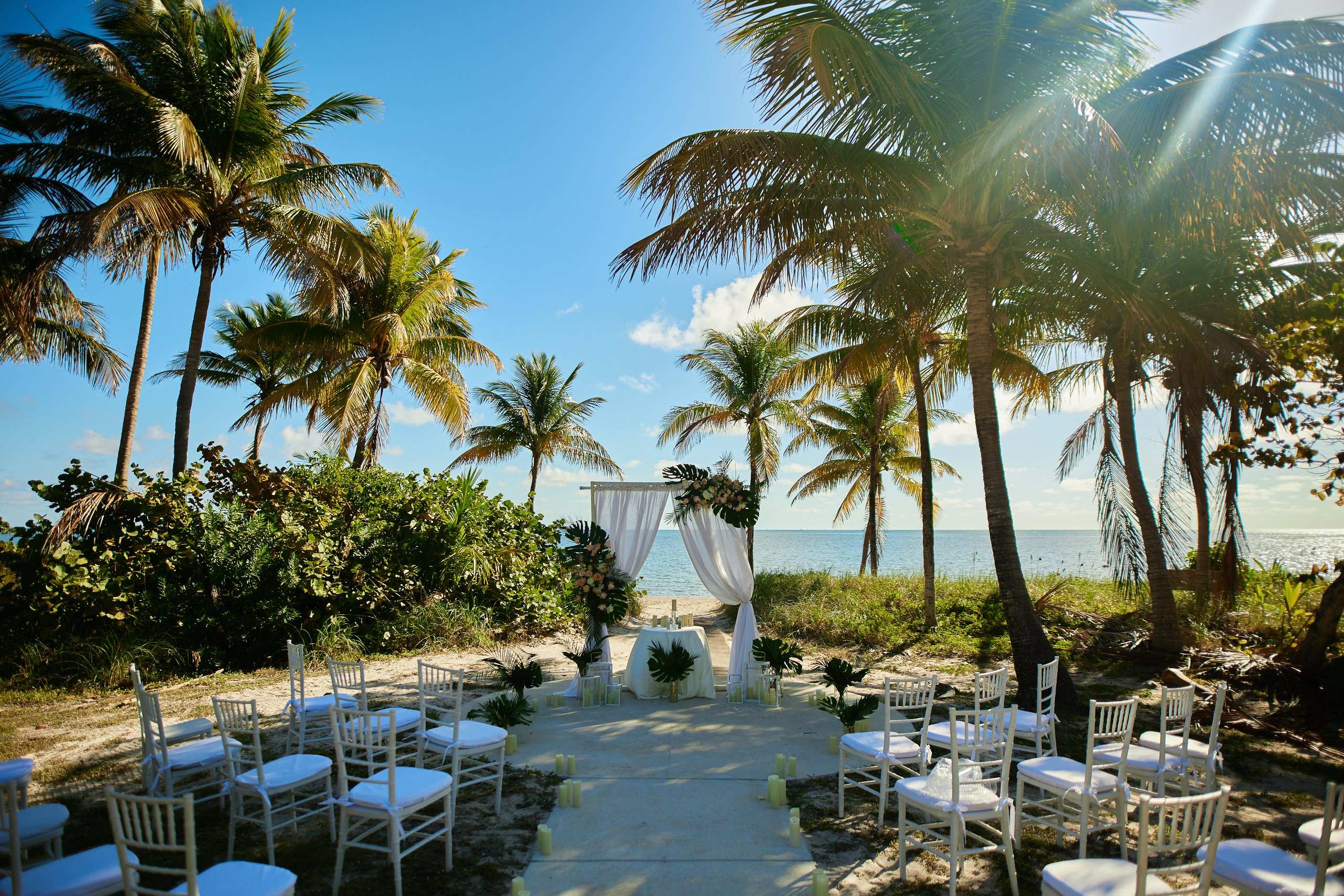 Ceremony among palm trees by the ocean