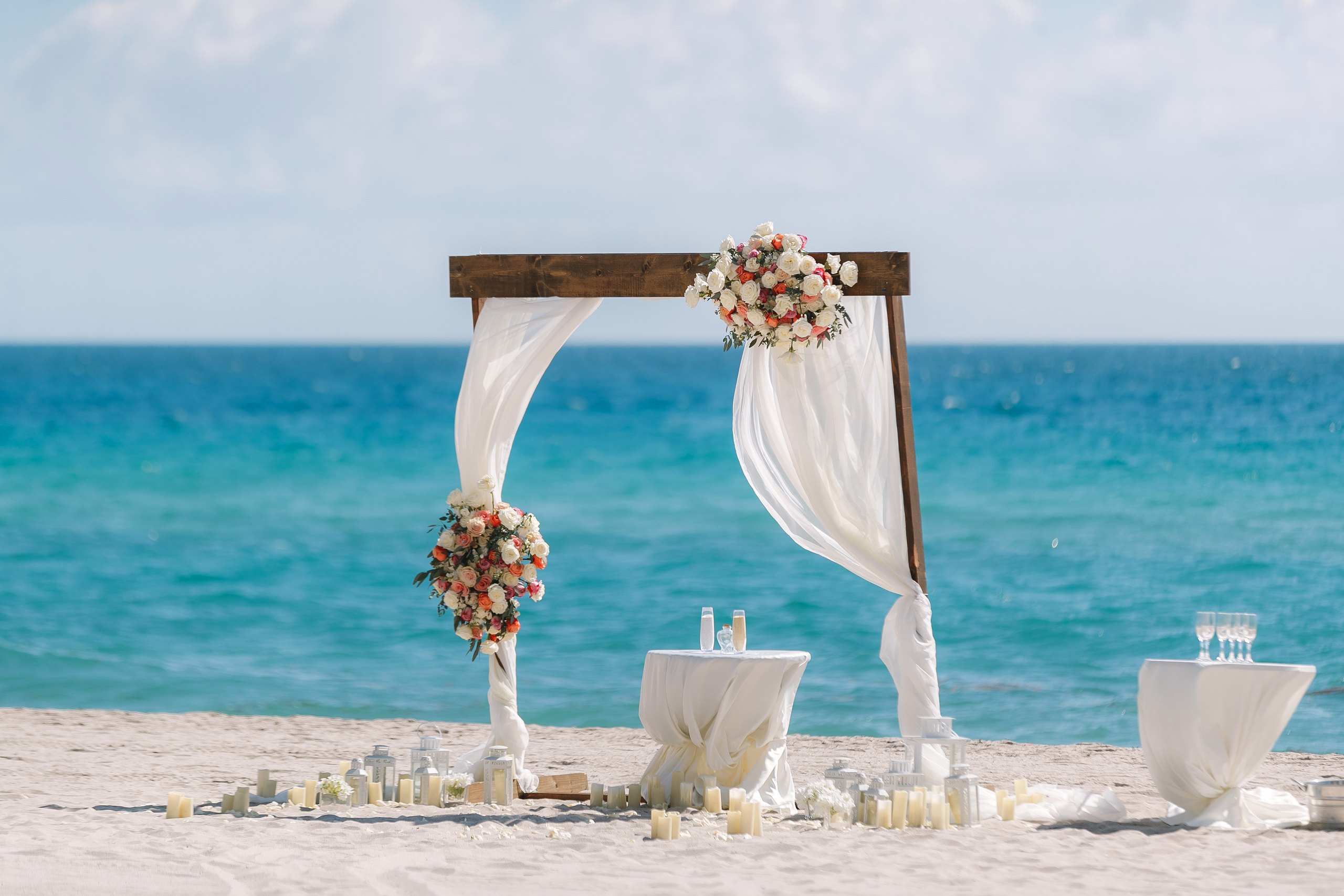 Wooden arch with flowers set for a beach ceremony