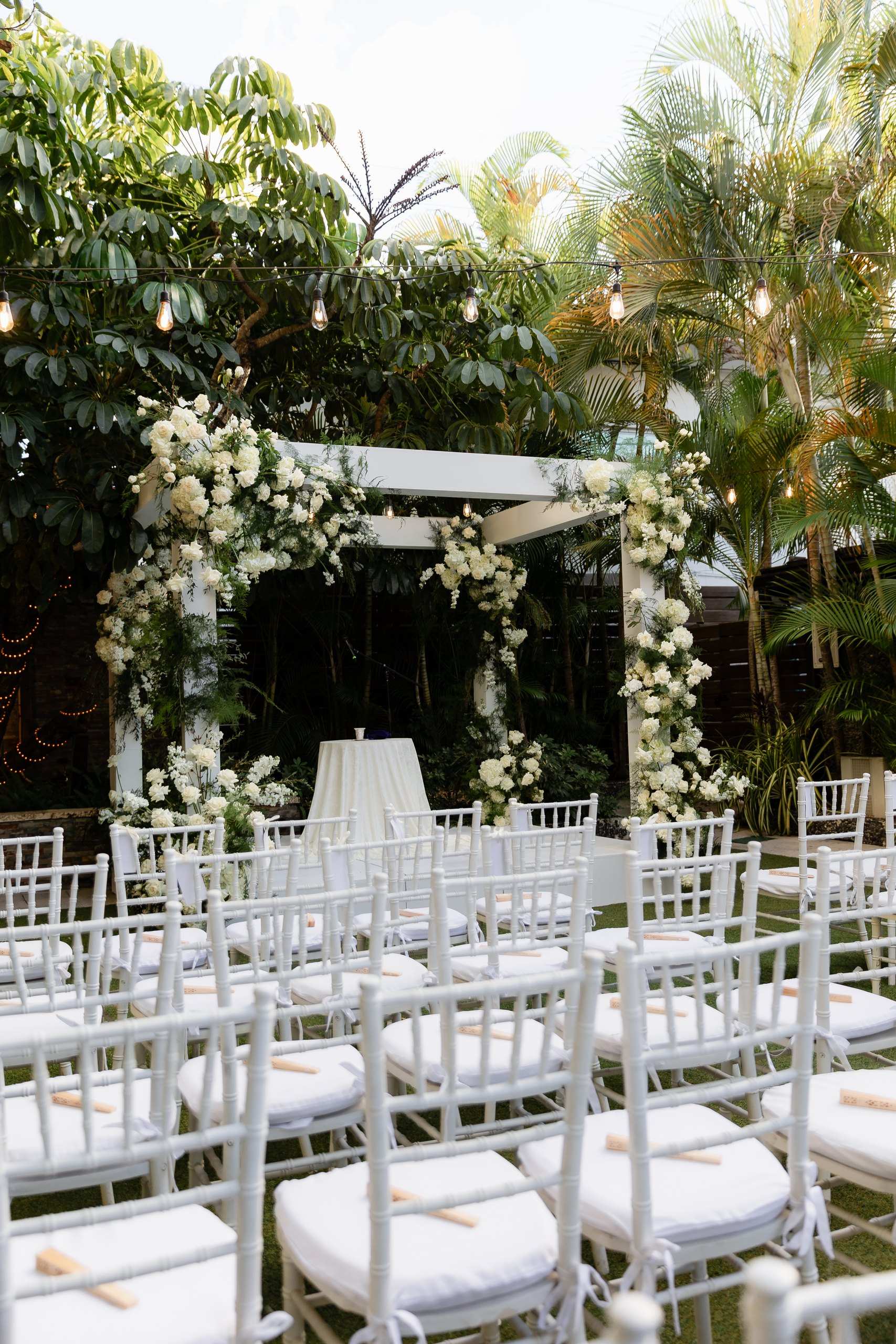 Four post arch with fabric draping in a garden