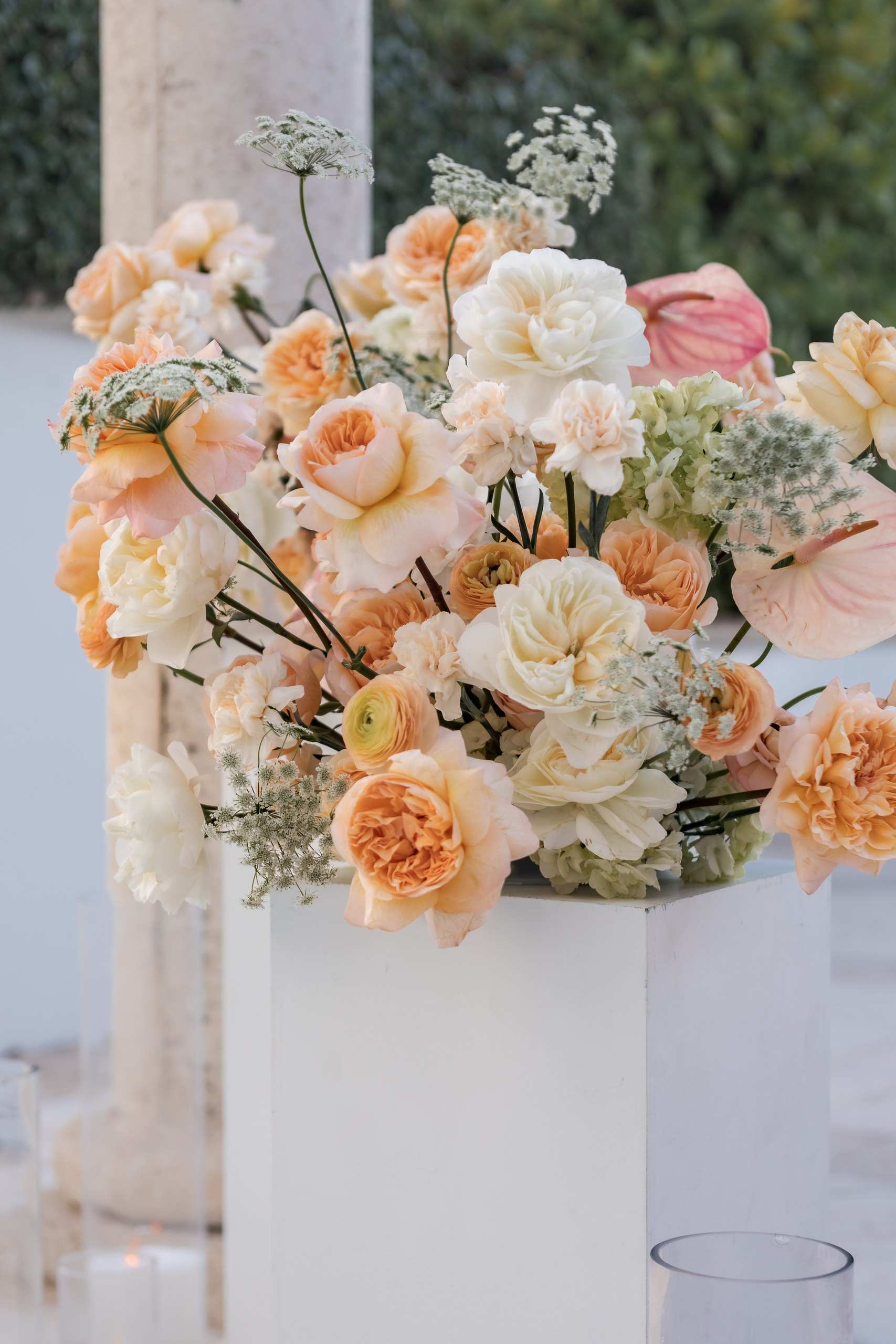 Peach flowers on white pedestals