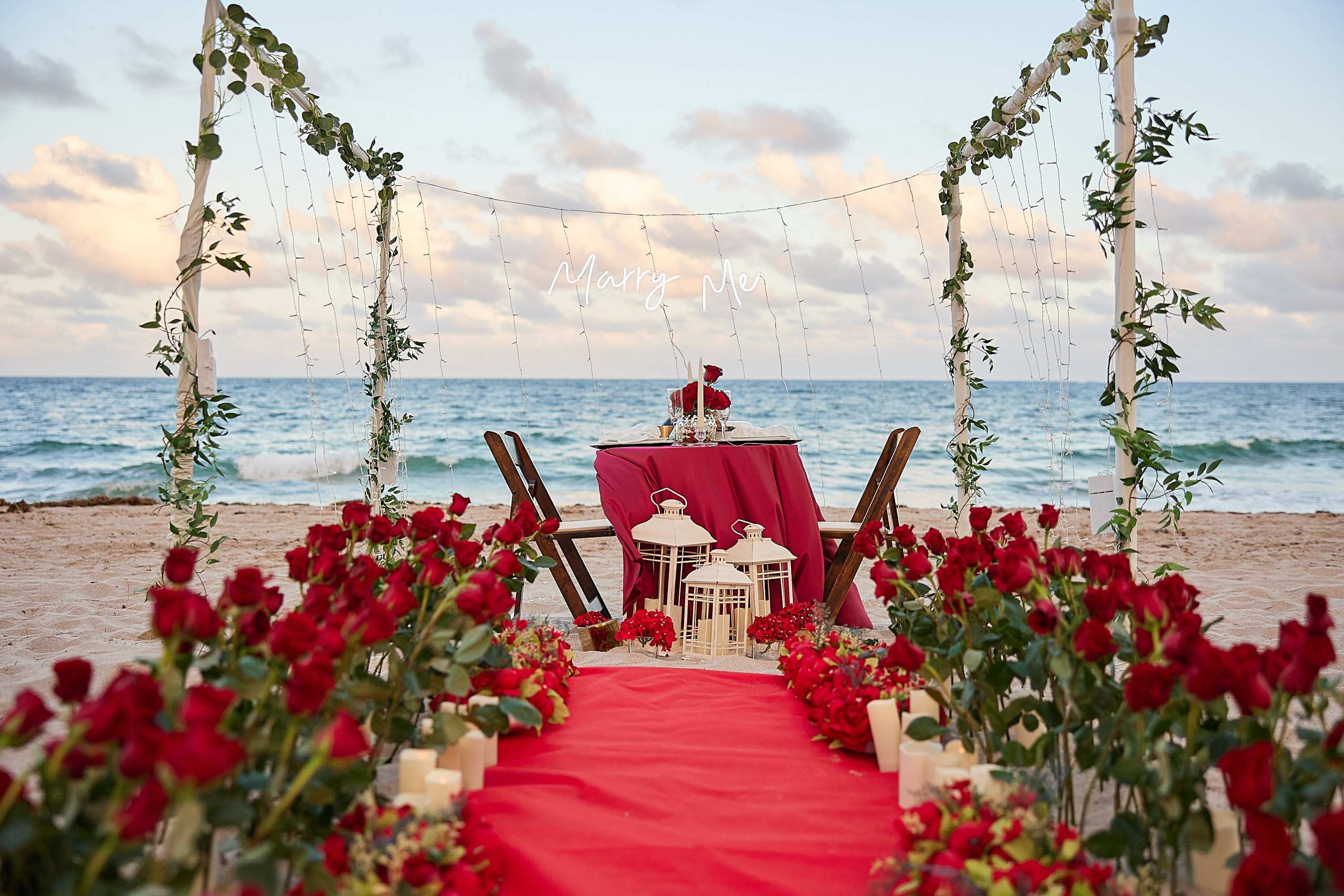 Carpet walkway leading to a dinner table on the beach