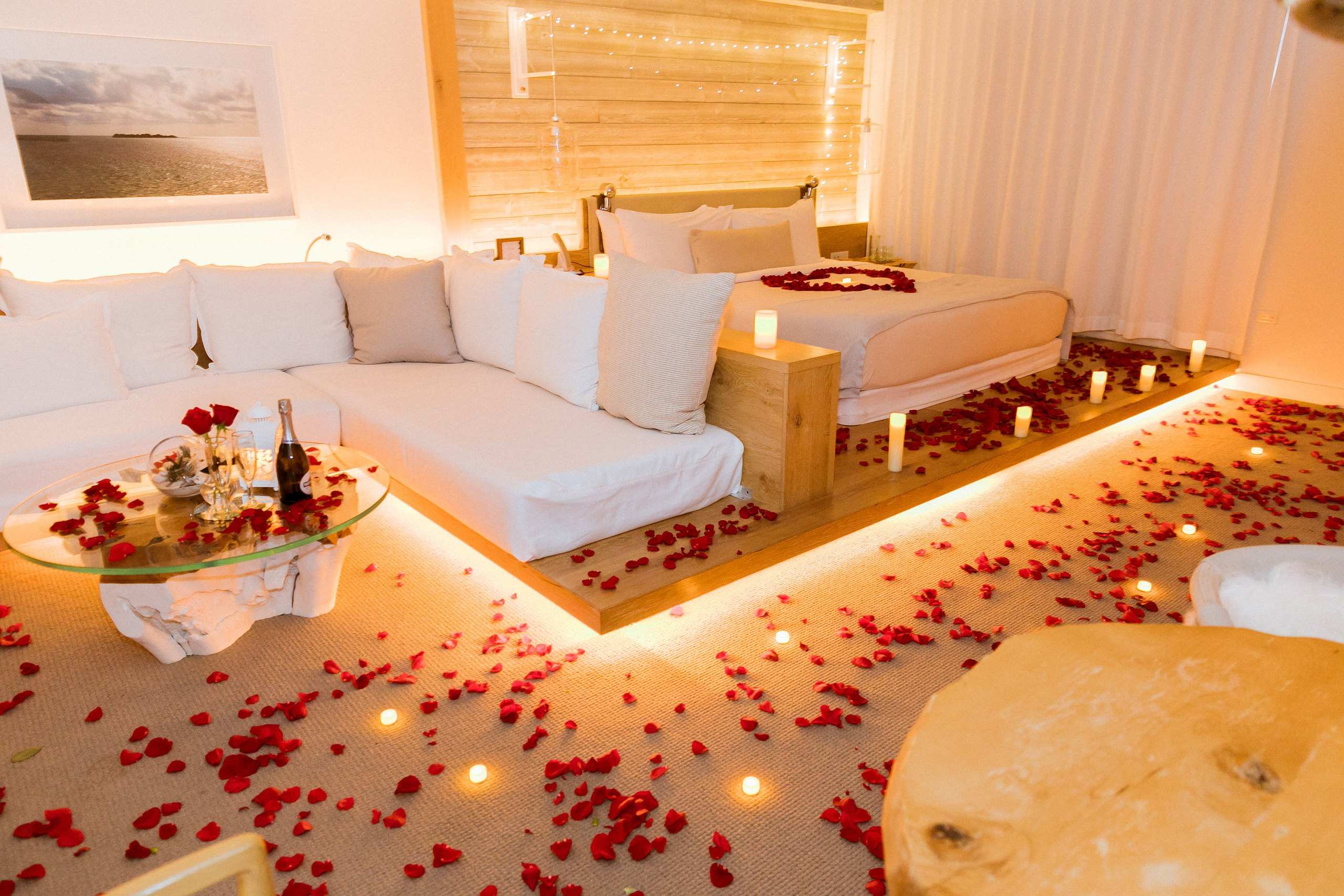 Room covered in rose petals, roses and candles