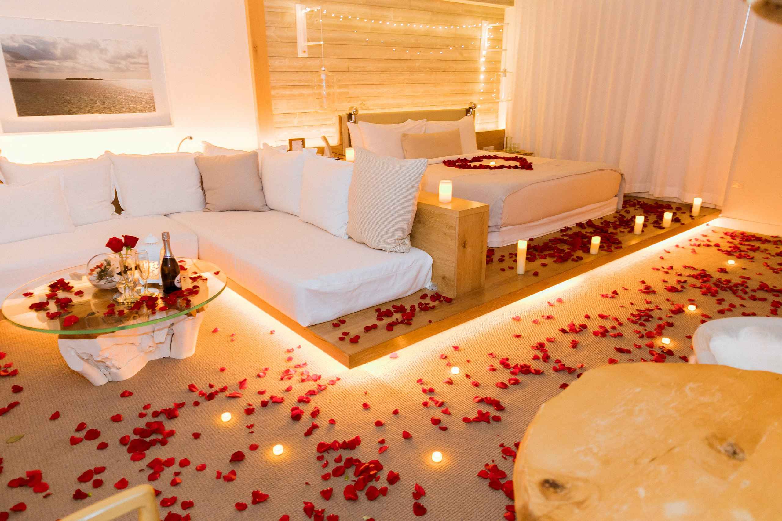 Room covered in rose petals, roses and candles