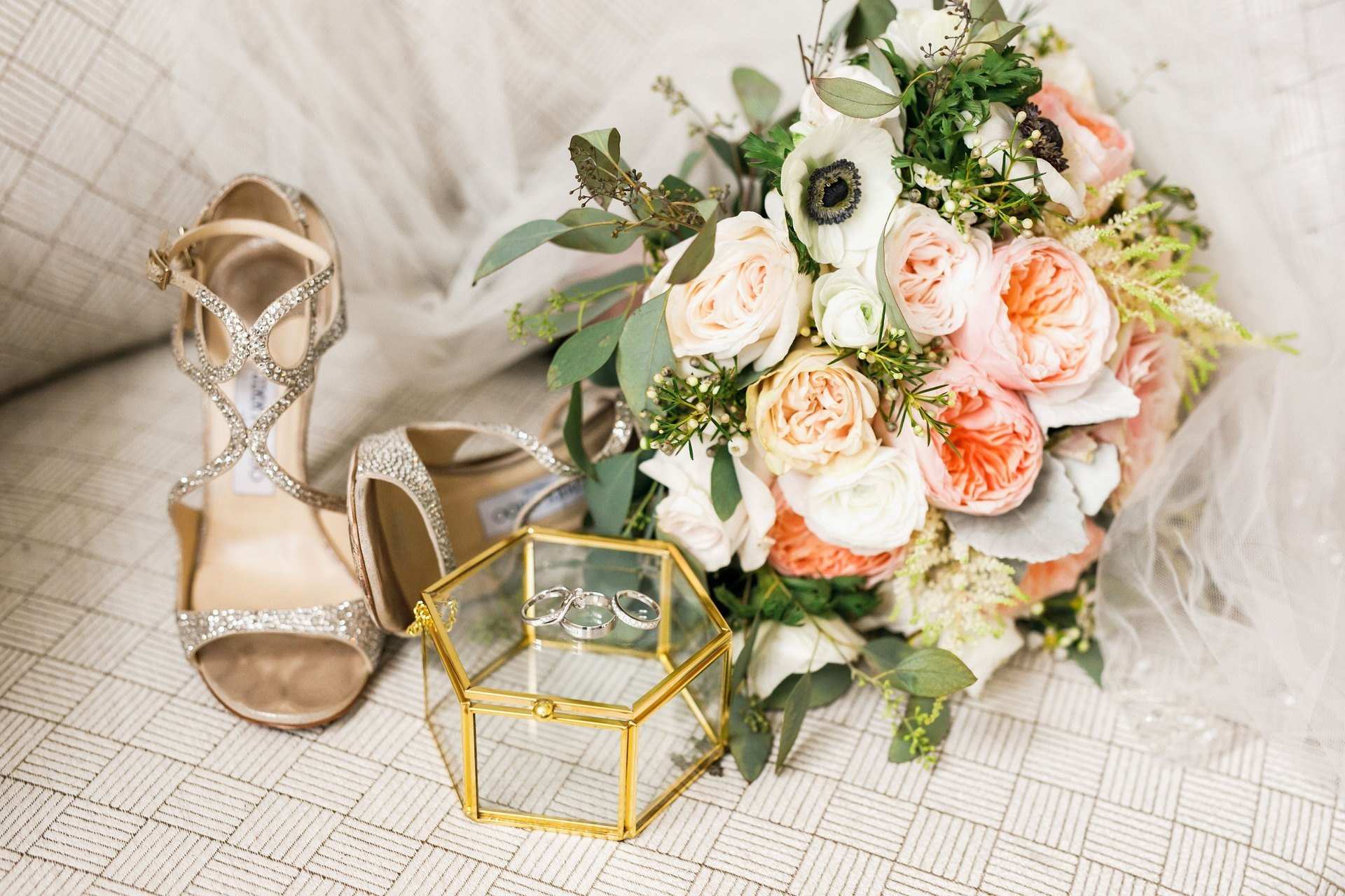 Bridal shoes beside a bouquet