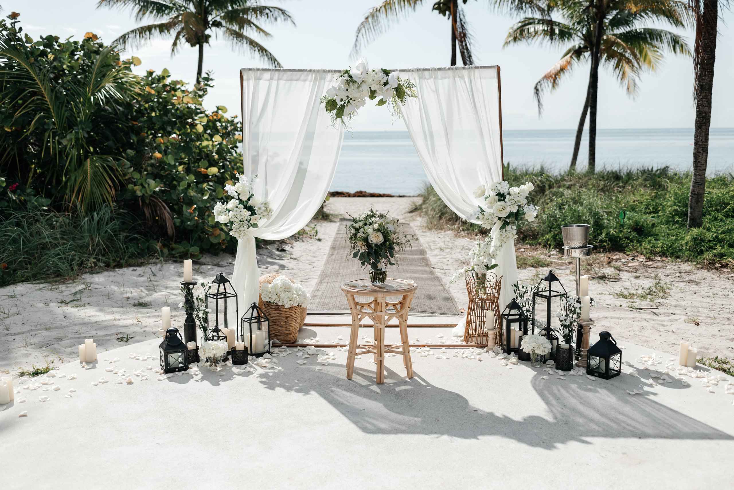 Two post arch with lanterns on the beach