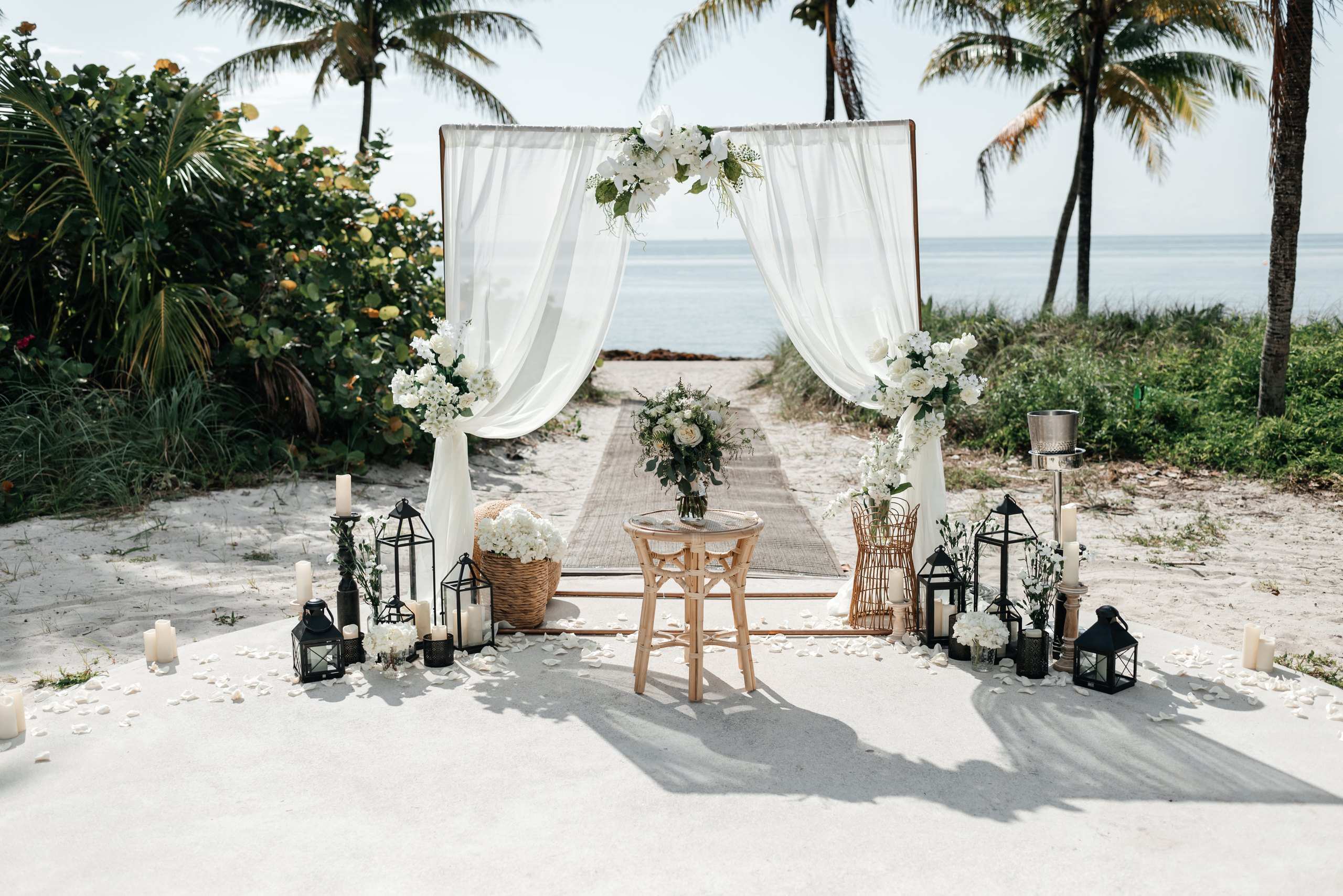 Two post arch with lanterns on the beach