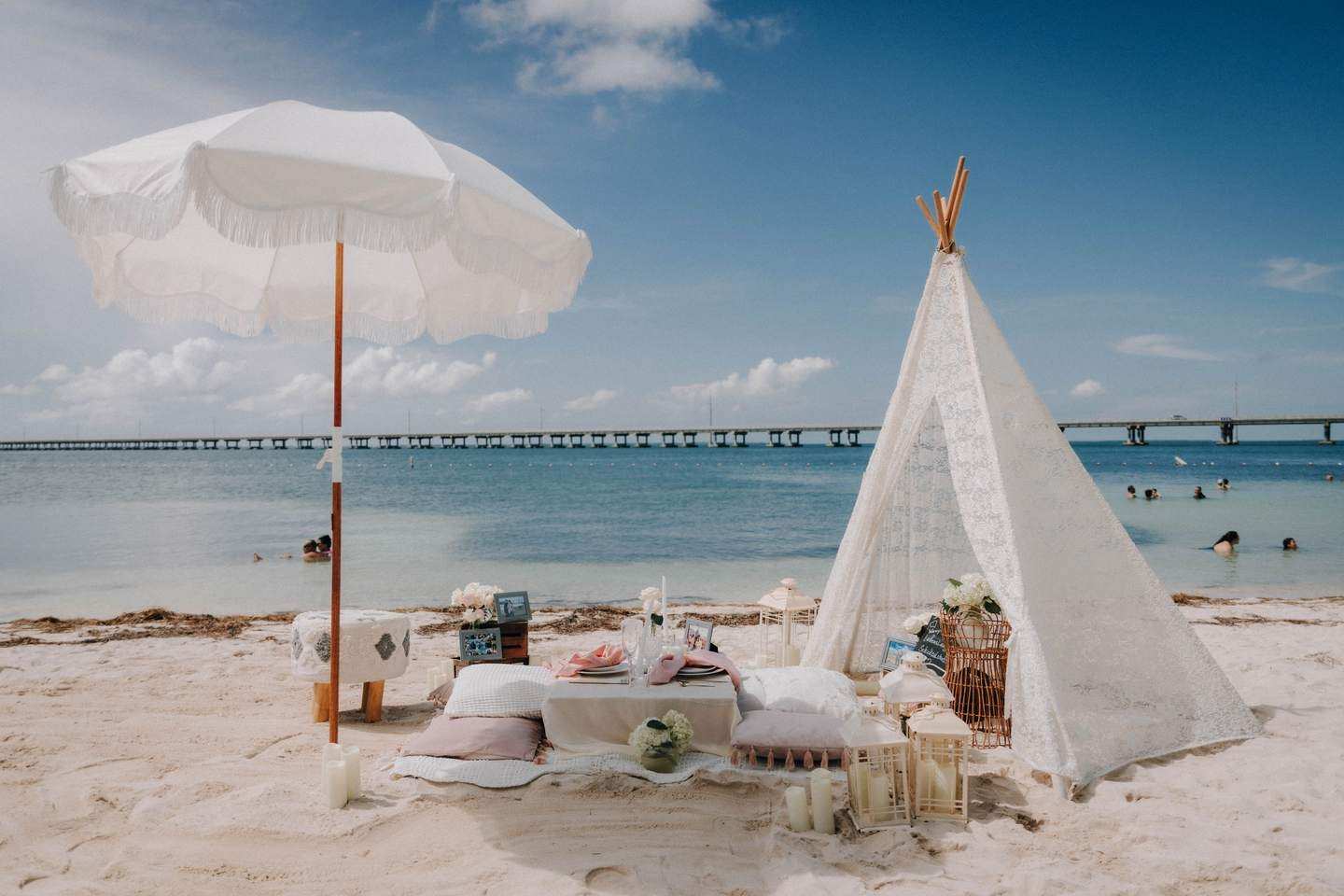 Picnic under a white shade with rugs and cushions